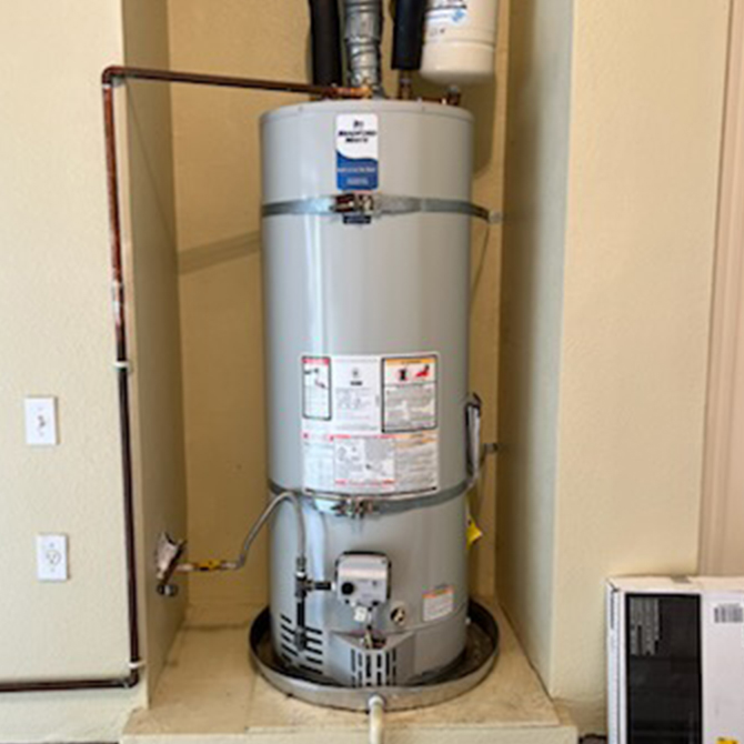 New residential water heater installation with tank system and connected piping, showcasing professional water heater installation services for efficient home hot water.